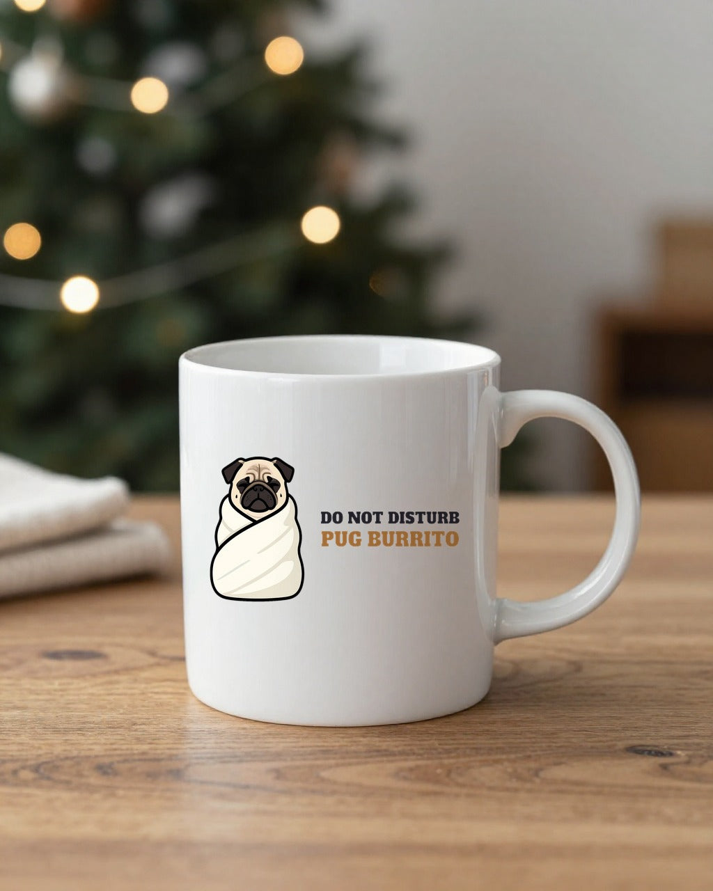 Pug burrito mug on a table by a Christmas tree