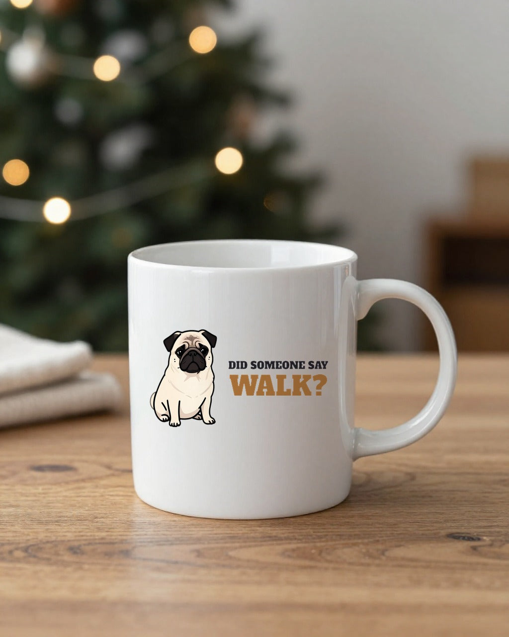 Pug side eye mug on a table by a Christmas tree